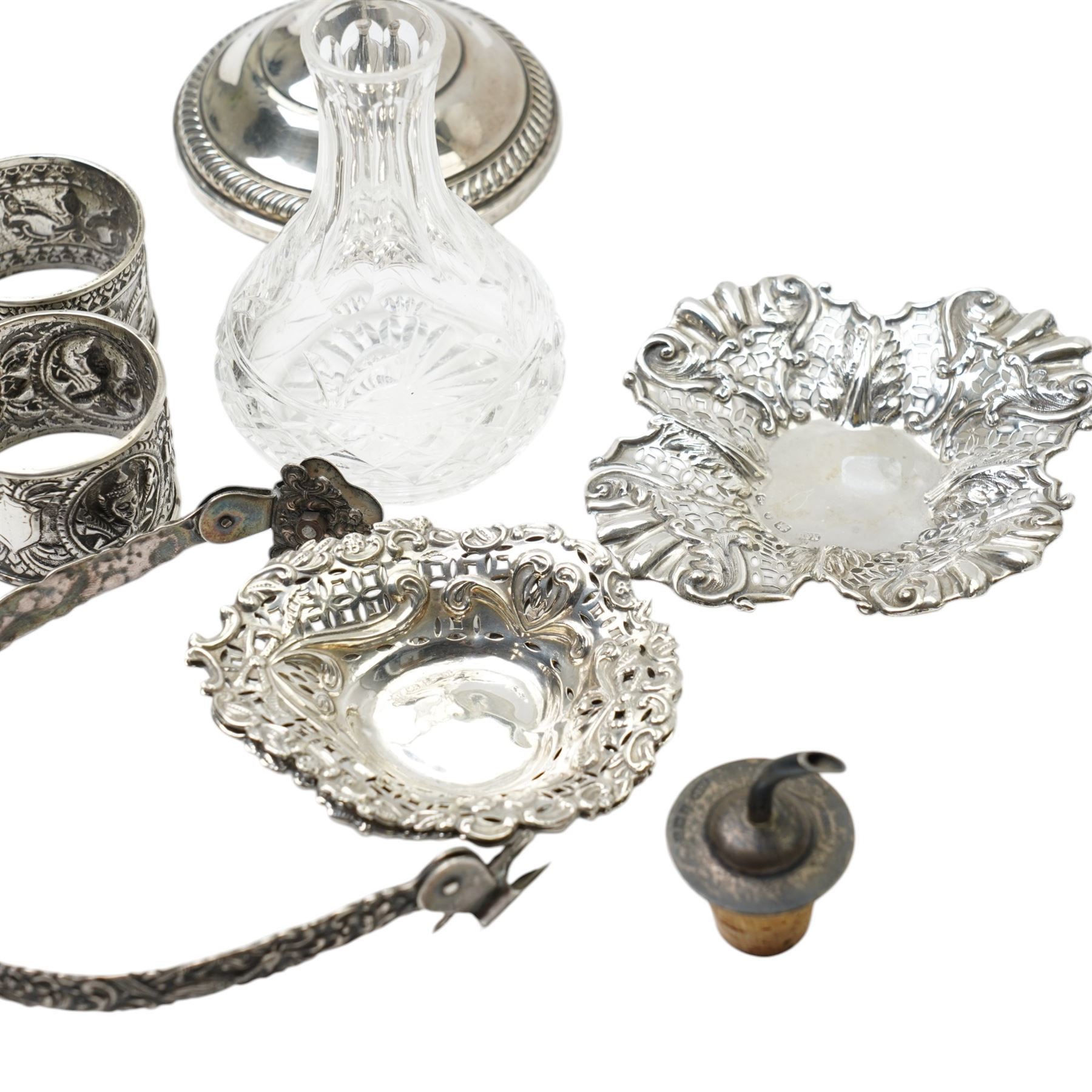 Two Indian white metal napkin rings, sterling silver candlestick, pair of silver heart shape sweetmeat dishes Chester 1895, single sweetmeat dish and other items