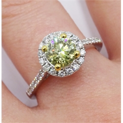 18ct white gold diamond halo ring, the central round brilliant cut fancy yellow diamond of 1.02 carat, with white diamond surround, gallery and shoulders, stamped K18, with GIA report