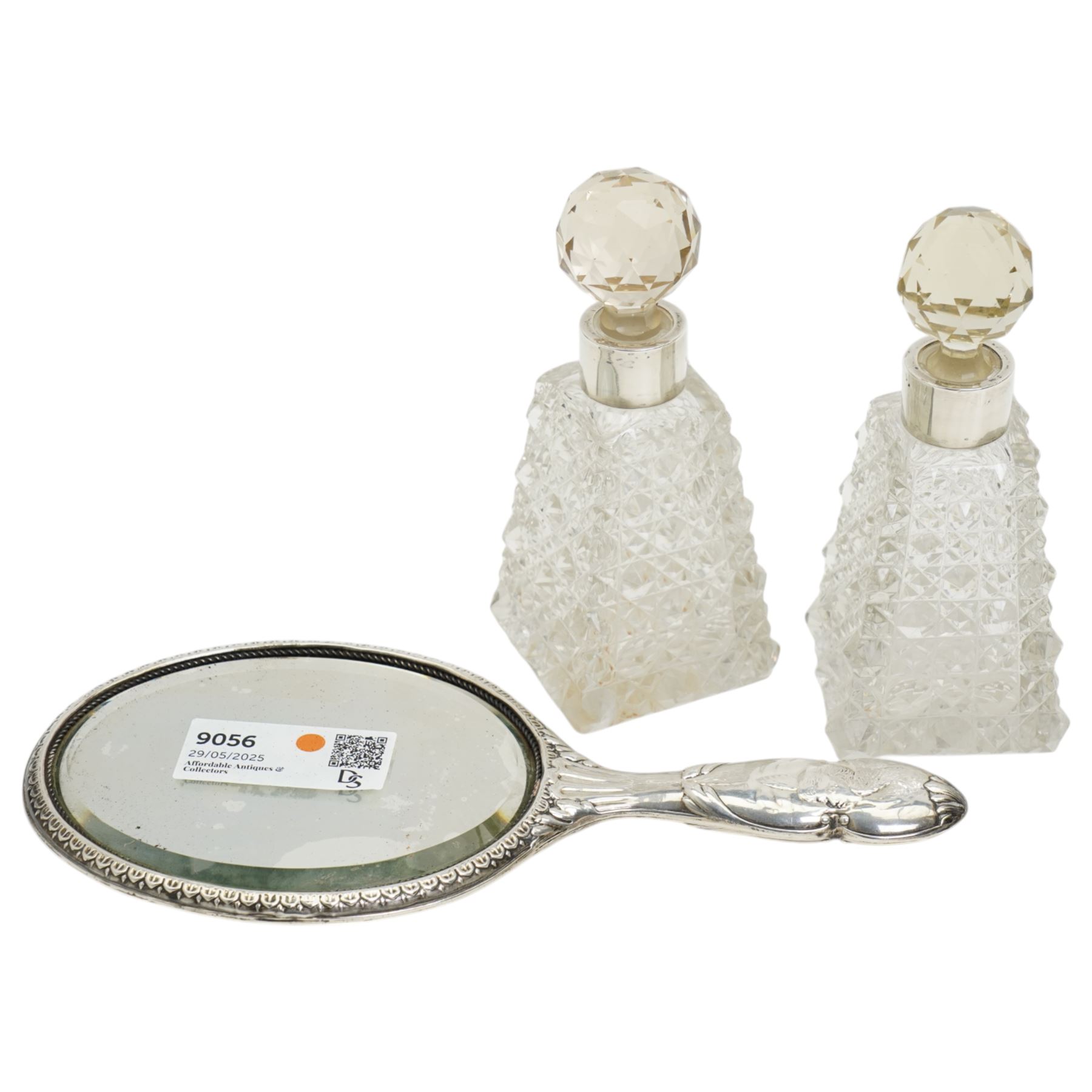 Edwardian silver backed hand mirror decorated with angels heads Chester 1903 and pair of Victorian glass and silver mounted scent flasks Chester 1894