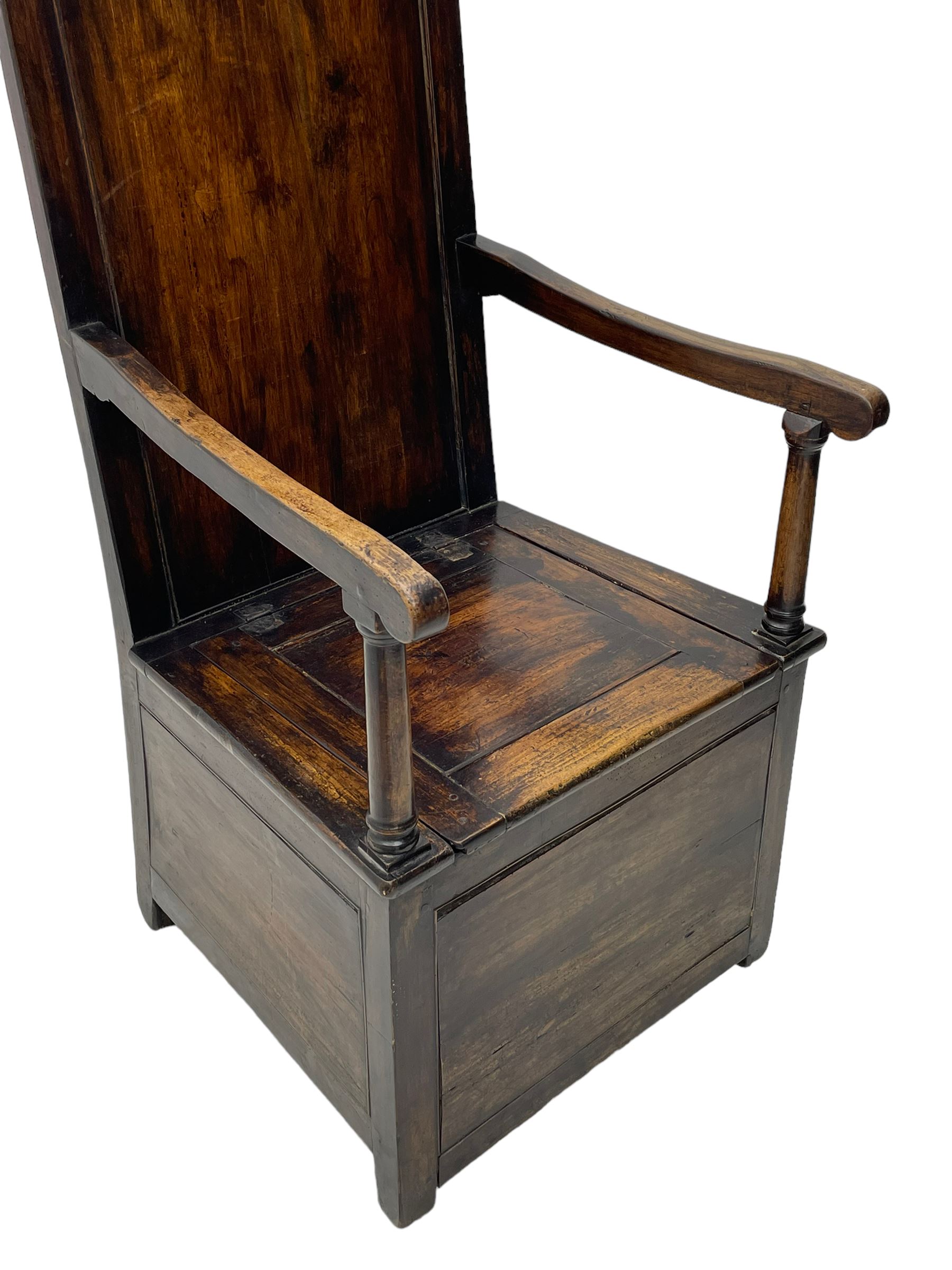 18th century elm box-seat lambing chair, dished cresting rail over panelled back, panelled hinged lid flanked by two turned arm supports