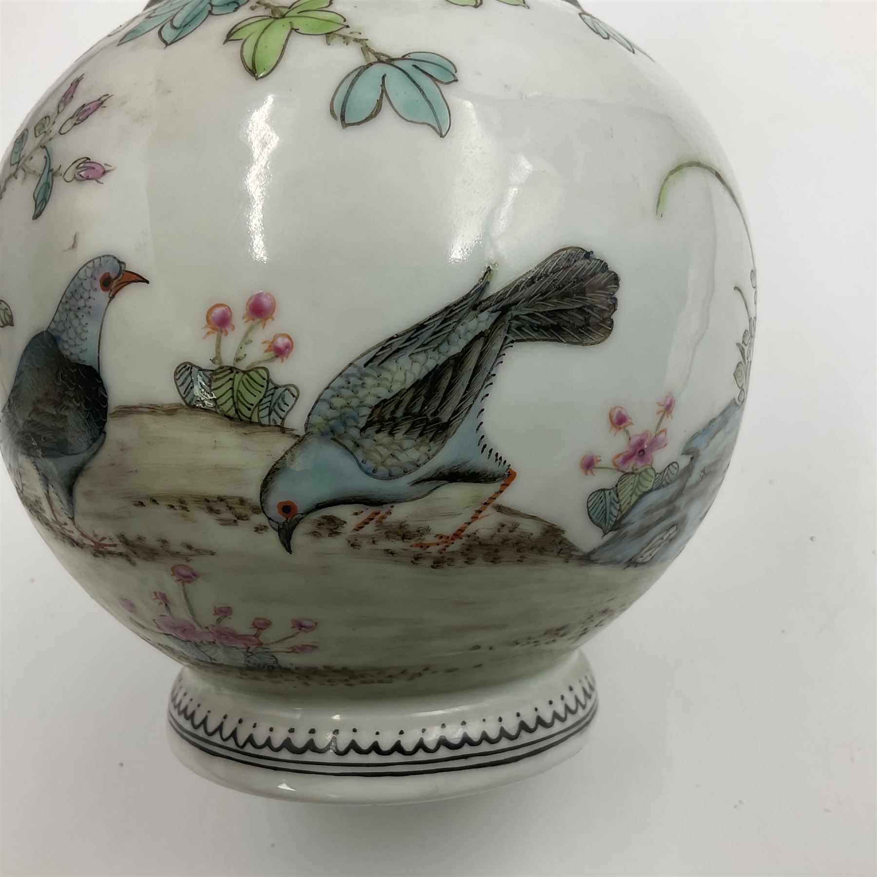 Pair of Chinese Republic porcelain vases, each painted in Famille Rose enamels with pairs of pigeons amidst peony, rock, flowering plants and leafy branches, possibly Qianlong seal beneath, H22cm 