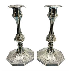 Pair of mid 19th century Elkington & Co silver plated candlesticks,  the octagonal columns of baluster form engraved with floral and foliate scroll decoration, impressed marks Elkington Mason & Co. Date Letter for 1857 to base, H22cm