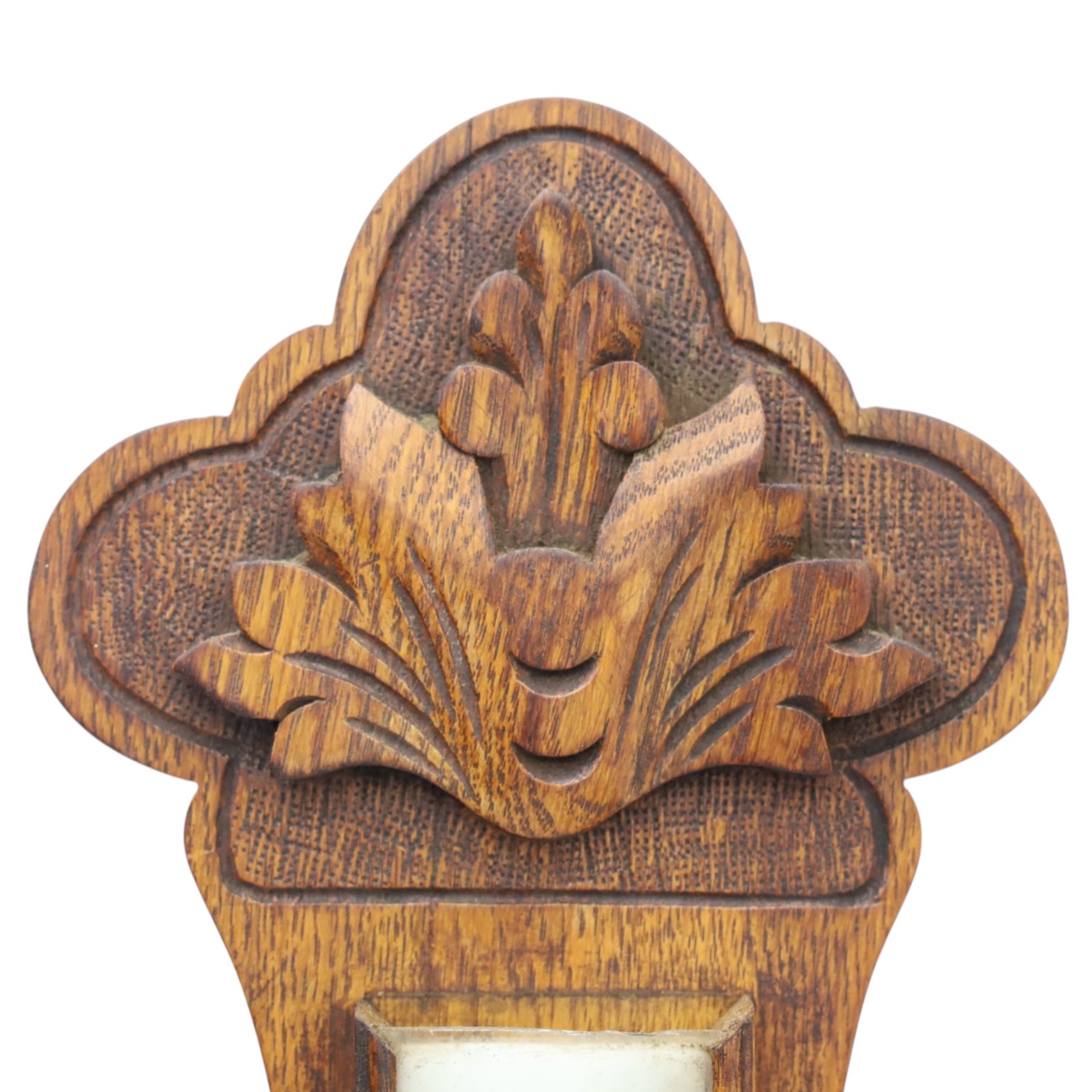 Late Victorian carved oak aneroid barometer, the foliate crest above a glazed thermometer and circular dial, with further carved decoration below, H 75cm