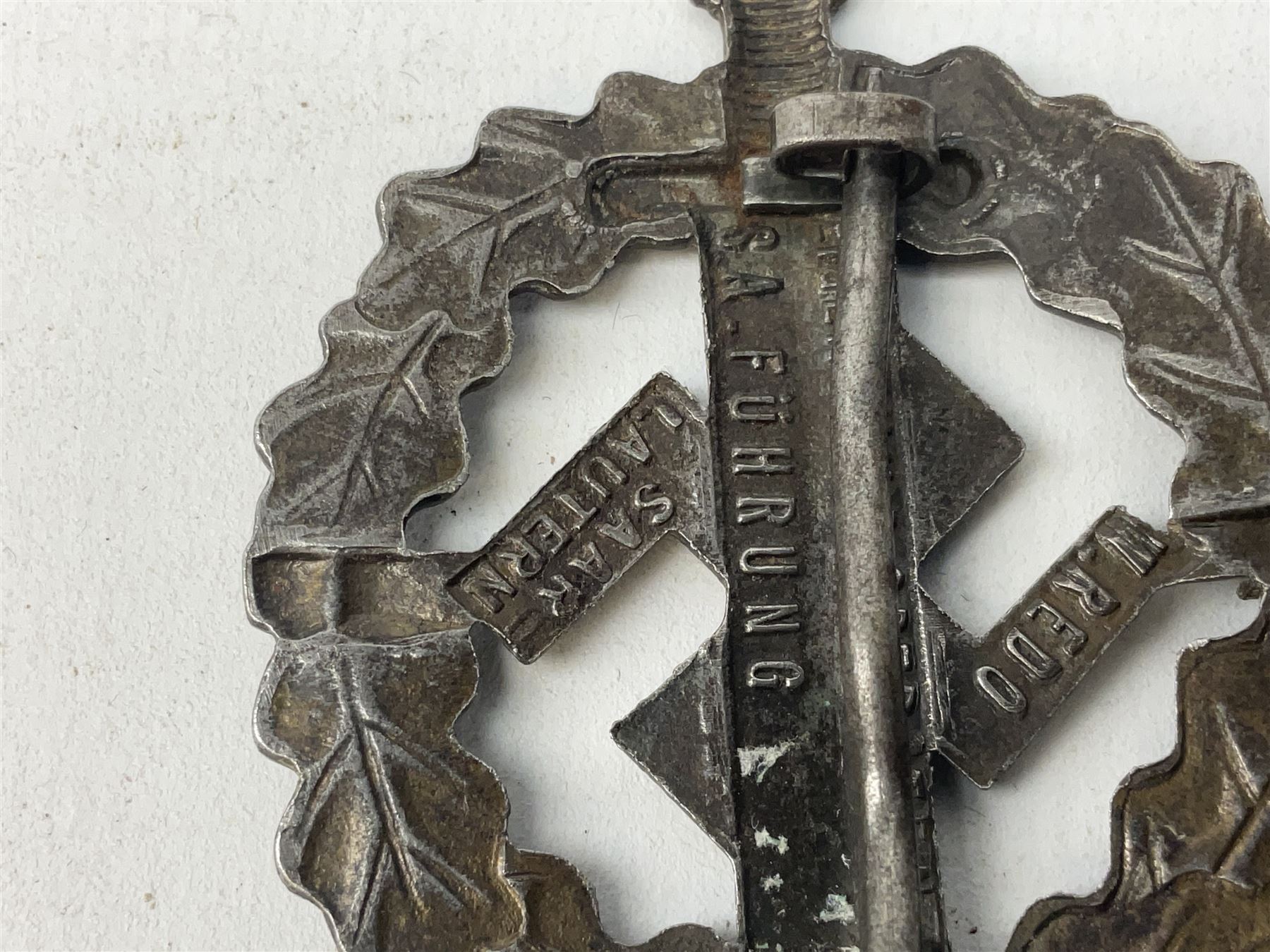 Two WW2 German Sports badges - SA sports badge marked verso 'W.Redo Eigentum D. Obersten SA. Fuhrung Saar Lautern'; and DRL sports badge marked verso 'Wernstein Jena D.R.G.M. 35269' (2)