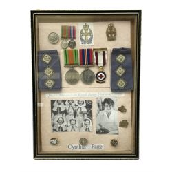 Framed display of medals and badges rela
