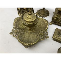 Collection of victorian and later brass desk accessories, to include a letter holder with cherub design, ink well of square form with hinged lid, brass table bell, brass casket with relief decoration, etc  