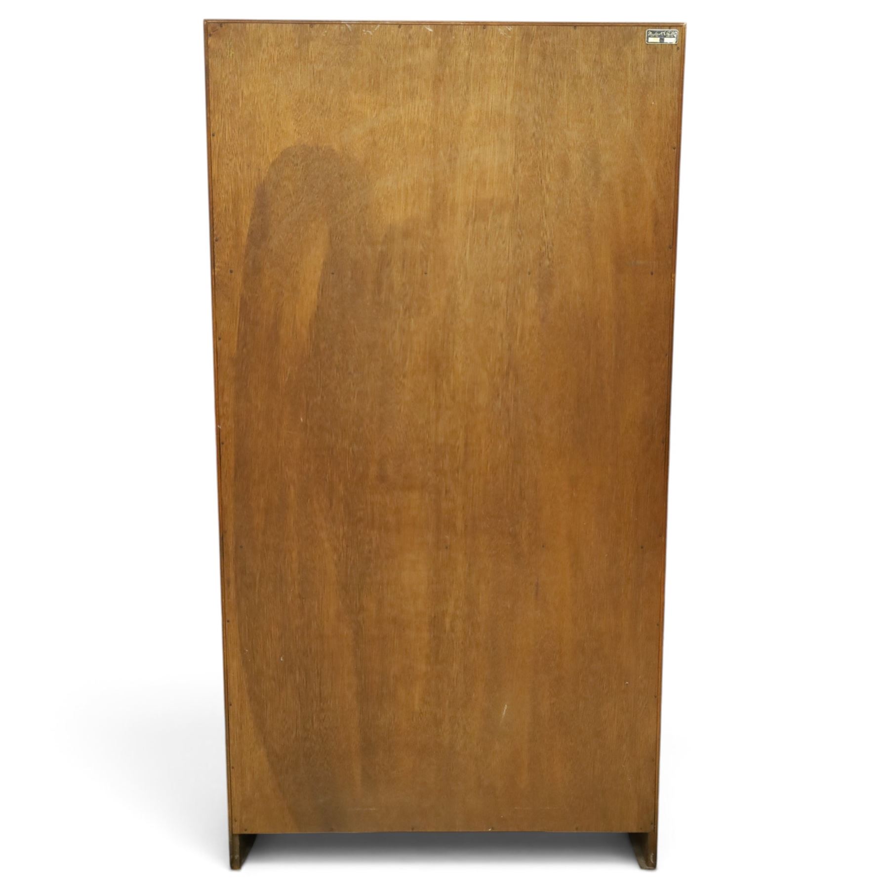 Herbert E Gibbs - Mid 20th century teak glazed bookcase cabinet, rectangular form with two sliding glazed doors enclosing adjustable shelves, lower cupboard enclosed by twin doors and fitted with internal shelf, on plinth base