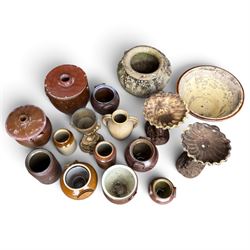 Large assorted collection of glazed stoneware jars and planters, with two lidded crocks, a brass urn and three decorative garden planters, including a pair of shell-form examples