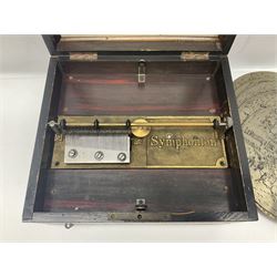 Late 19th century Symphonion disc musical box for spares or repair, inlaid walnut case with front lever action, playing 25.5cm discs on a 10.5cm steel comb with forty-nine teeth, musical scene of cherubs under the lid, L33cm; together with twelve 25.5cm discs