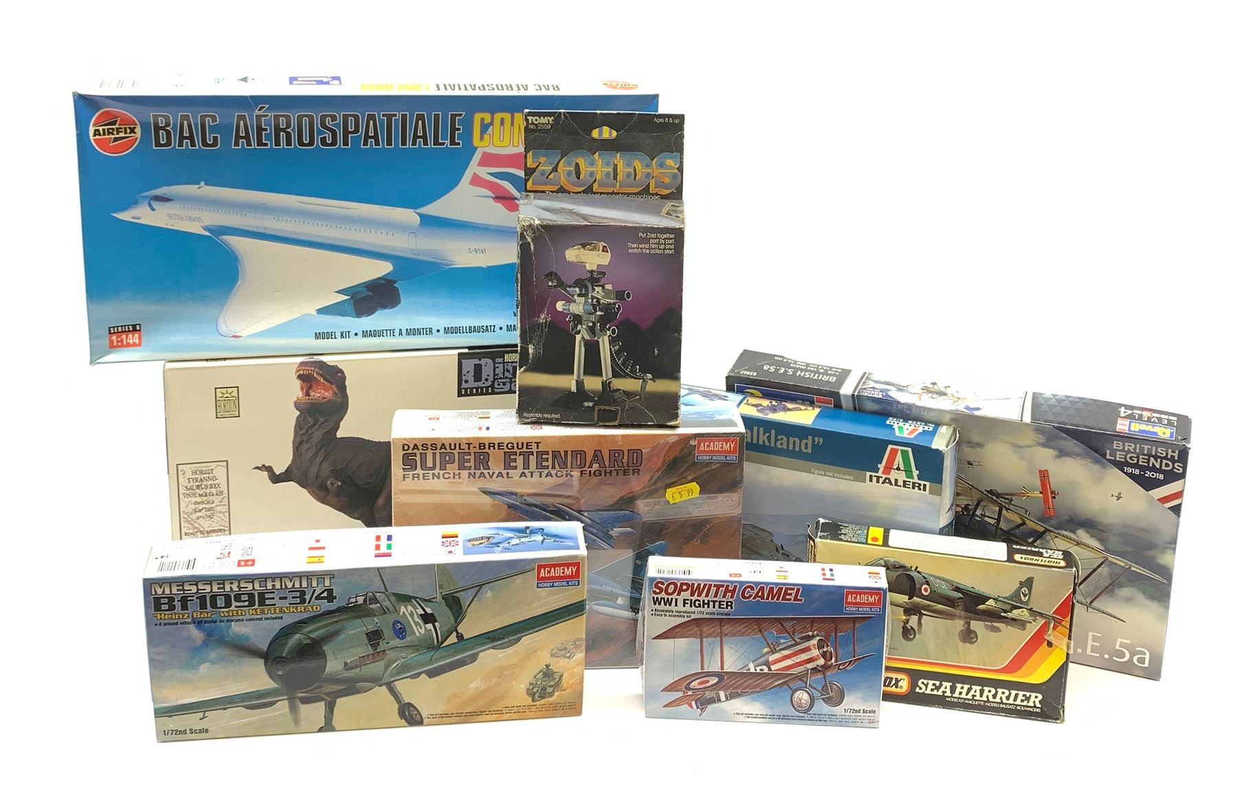 Nine assorted plastic model kits by various makers including Airfix 1/144th scale Concorde, Revell British S.E. bi-plane, Horizon Tyrannosaurus Rex, Tomy Zoids, Matchbox Sea Harrier, Italeri Harrier Falkland and three aircraft by Academy; all boxed, most in factory sealed transparent packaging (9)