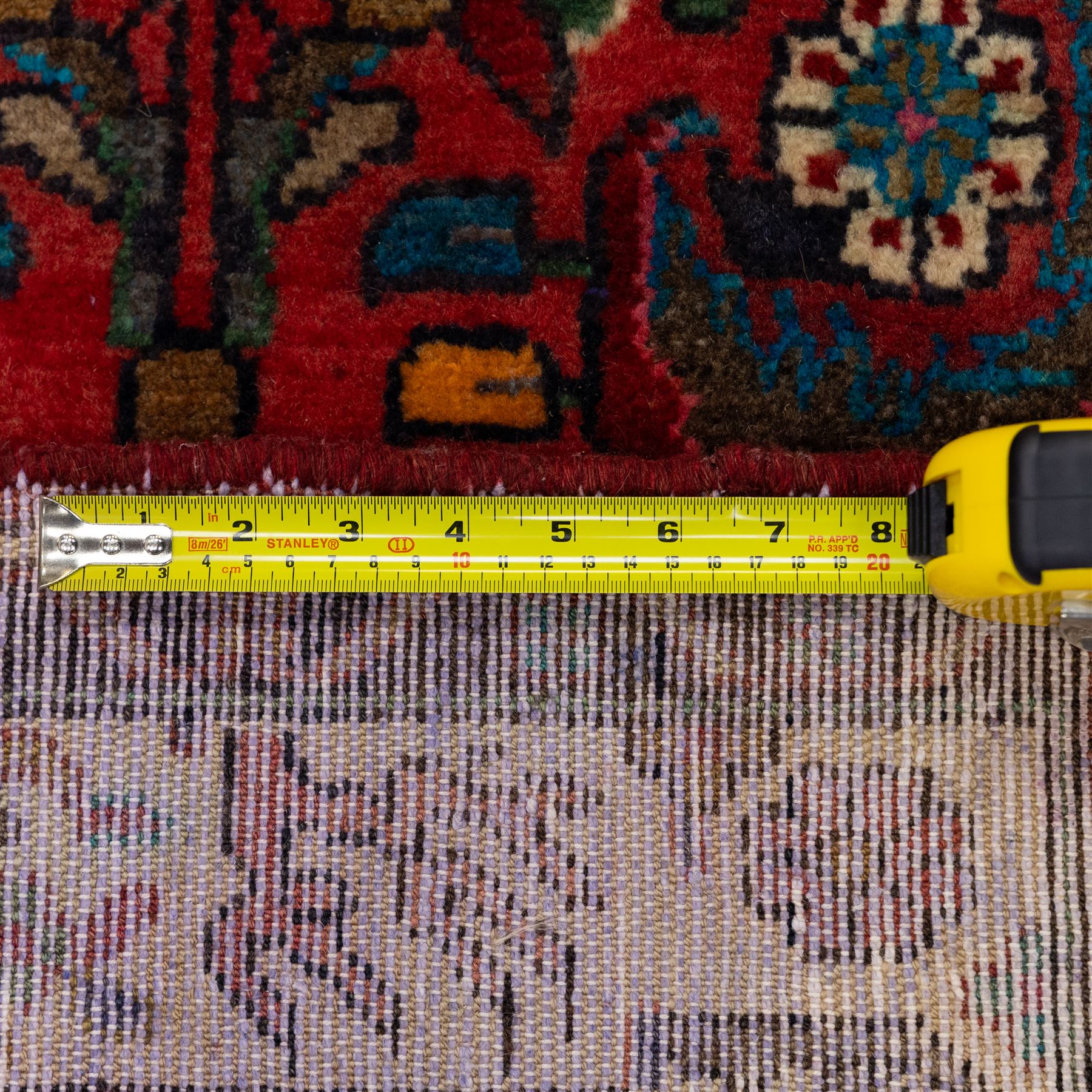 North West Persian Mahal hand-knotted runner, deep red ground, with a vertical arrangement of angular floral and geometric motifs, enclosed by an ivory border  of stylized leaves and rosettes, with guard stripes on indigo ground, cotton fringe ends 