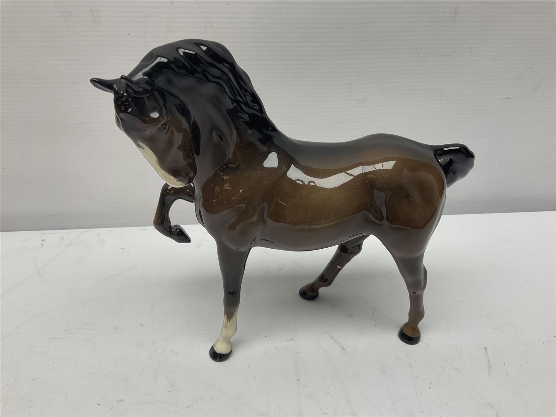 Four Beswick horses, including Exmoor no 1645, Black Beauty foal and two others 