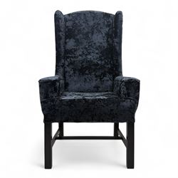 Oka - Pair of contemporary upholstered wingback armchairs, in black and blue textured velvet effect fabric, with tall scroll wing sides and square tapered legs joined by stretchers