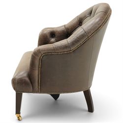 Georgian design tub-shaped club armchair, upholstered in back-buttoned dark tan leather with sprung seat, raised on square tapering supports with brass cups and castors