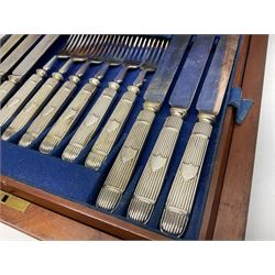 Victorian silver plated dessert set by Elkington & Co for twelve place settings, each reeded handle with vacant cartouche, each with Elkington & Co mark, date letter for 1861, and registration lozenge, contained within a mahogany case with vacant brass cartouche to the hinged cover, opening to reveal a Royal blue baize lined interior with removable tray, case H6cm W29.5cm D26.5cm