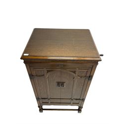 Early 20th century ‘HMV' 202 cabinet gramophone, oak cased, moulded top with foliate carved moulding hinges to reveal gramophone, two doors enclosing horn, on turned supports joined by moulded stretcher rails