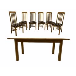 Light oak extending dining table, with six matching chairs, the seat pads upholstered in striped grey and black fabric