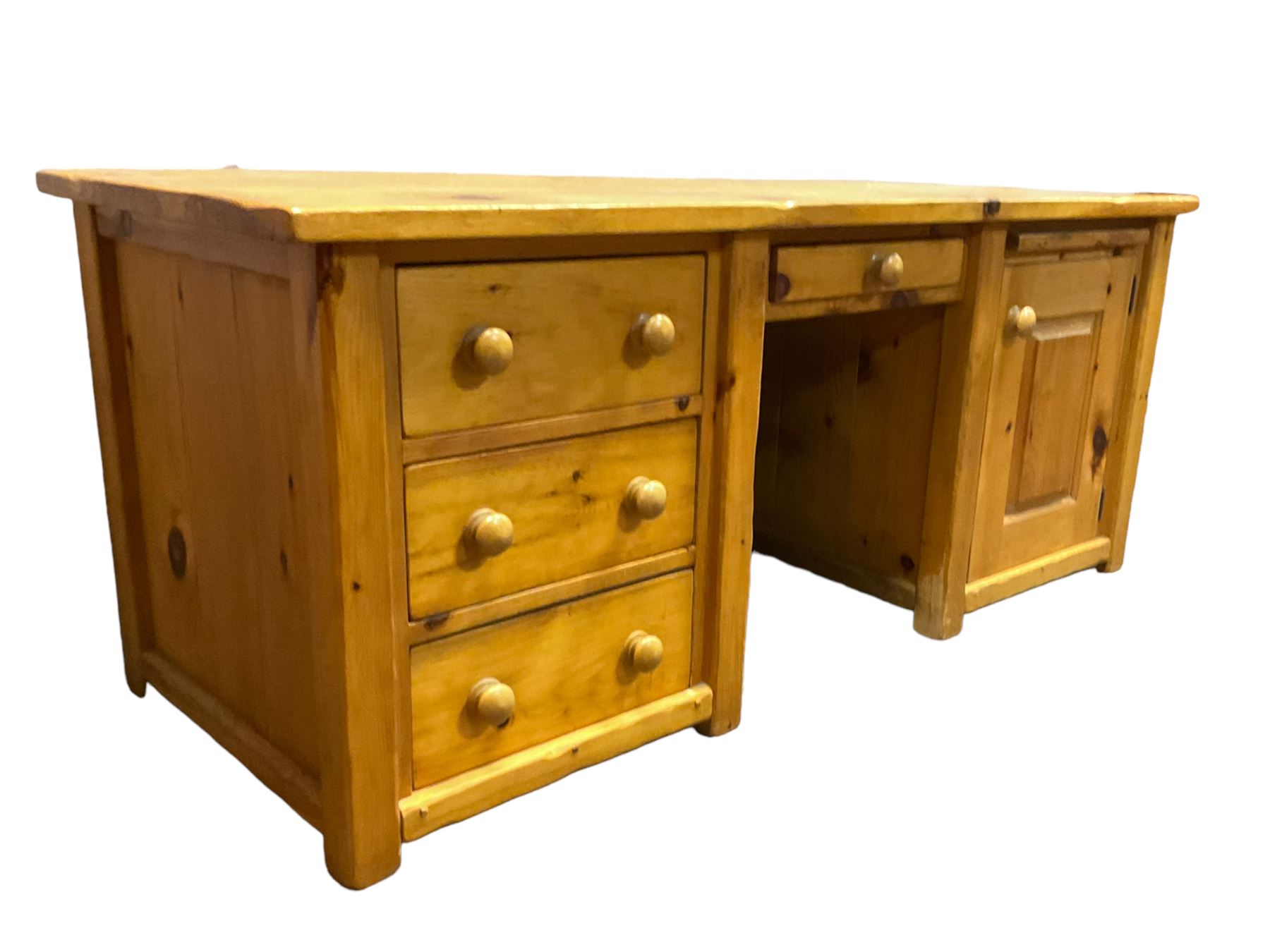 Large pine desk, rectangular top over four drawers, slide and panelled cupboard