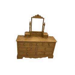 Pine dressing chest, raised rectangular swing mirror fitted with two drawers, the chest fitted with seven drawers