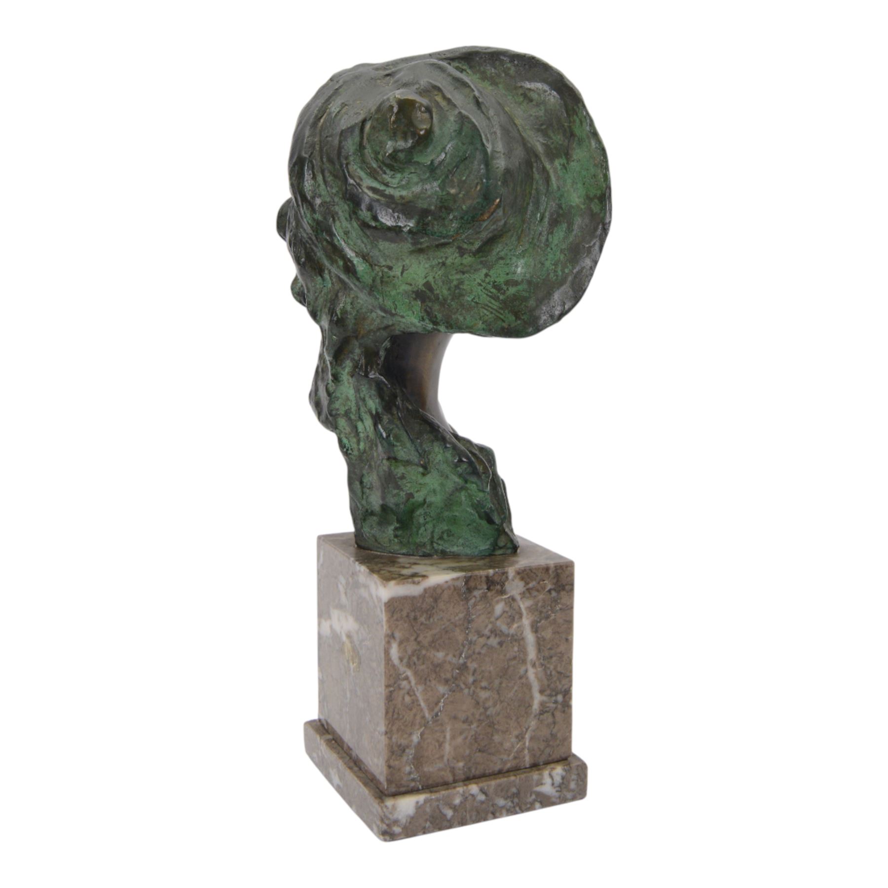 Bronze bust of a boy wearing a hat, upon a stepped marble base, H37cm