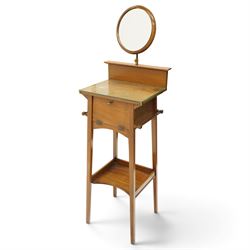 Early 20th century oak valet stand, raised back withy circular swivel mirror, over fall fr...