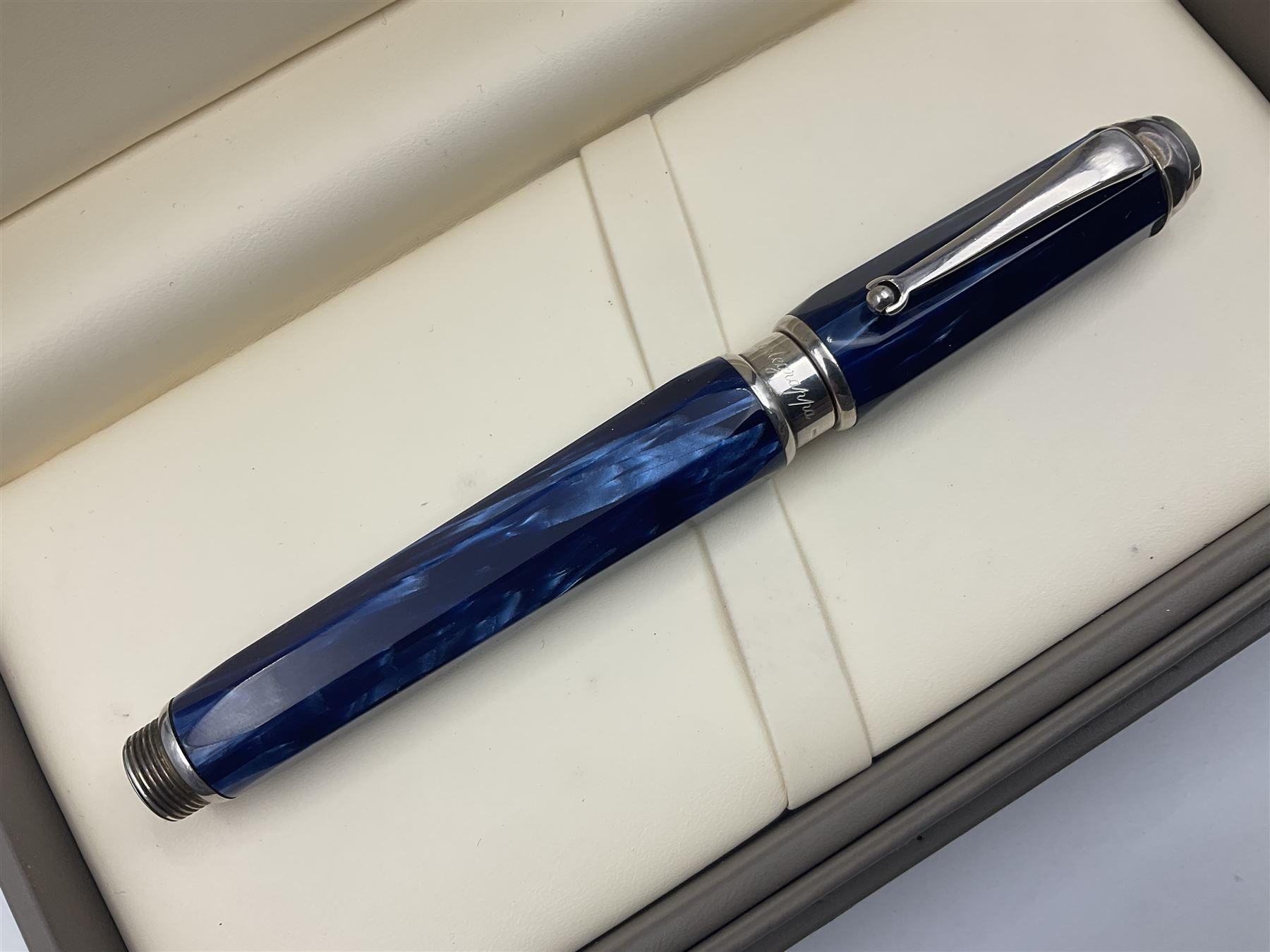 Montegrappa Emblema fountain pen, the blue pearl marbled barrel of octagonal form with silver mounts stamped 925 and silver mounted cap with 1912 emblem and clip with roller, in box, L13.5cm
