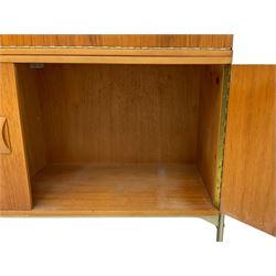 Remploy - mid-20th century teak sectional wall display unit or room divider, raised display cabinet section with sliding glass doors, central fall front section, lower double cupboard section and an additional sliding door section 