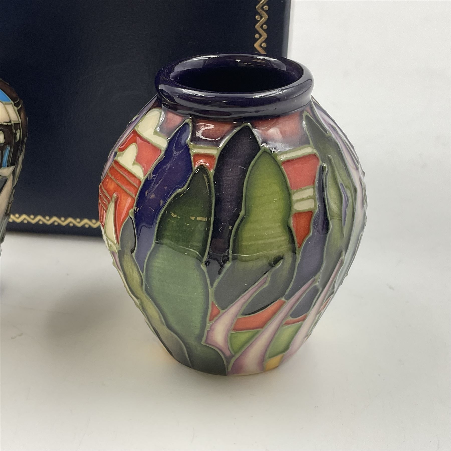 Two miniature Moorcroft vases, one decorated in the Lodge Hill pattern, circa 2007, H6cm,  and the other decorated in Made in Burslem circa 2011, H6cm  