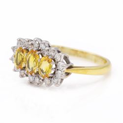 18ct gold yellow sapphire and diamond cluster ring, three oval cut sapphires, surrounded by twenty round brilliant cut diamonds, London 1988, total sapphire weight approx 1.15 carat, total diamond weight approx 0.50 carat