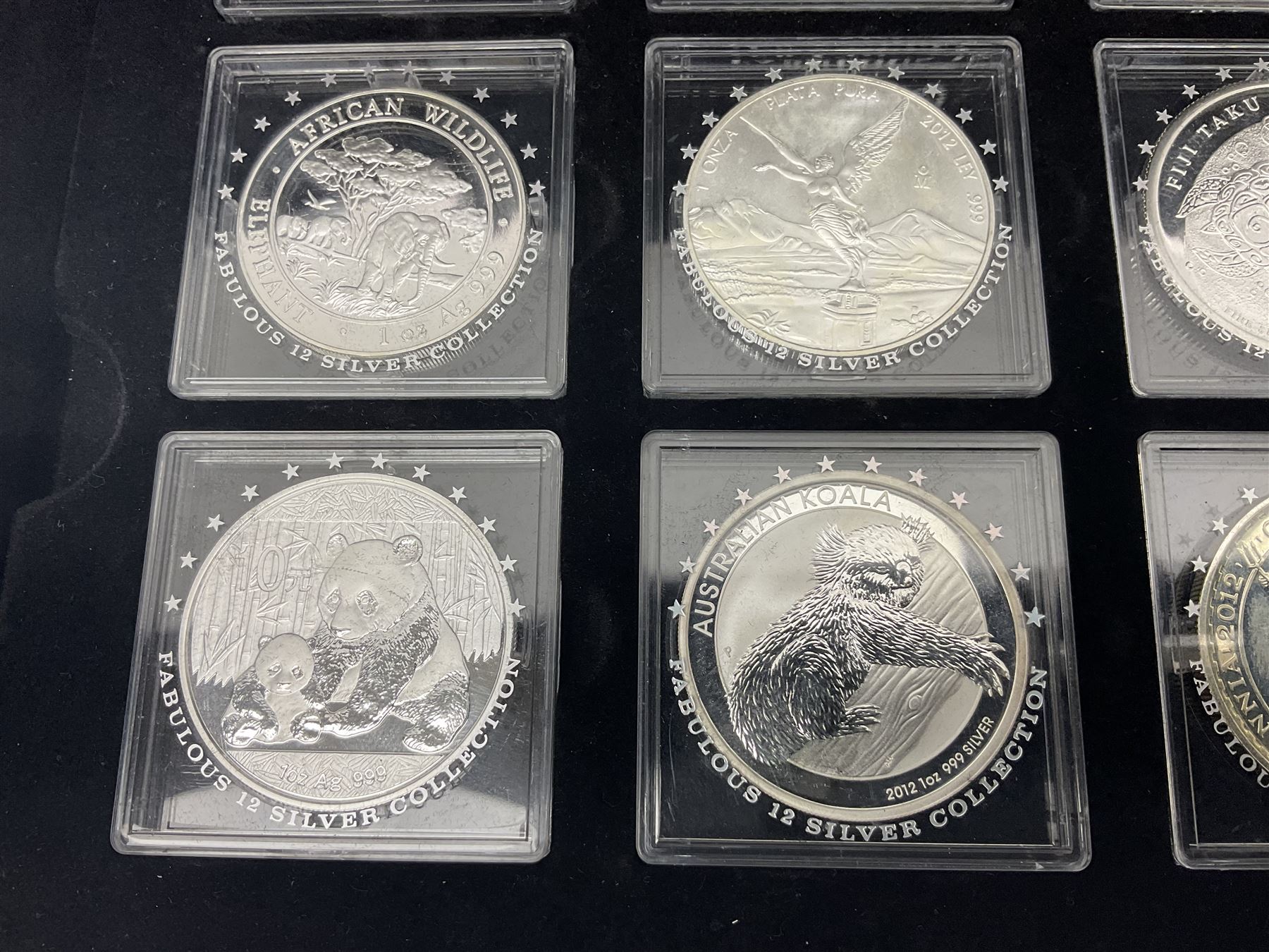 'The 2012 Fabulous 12 Silver Coin Collection' including Queen Elizabeth II Britannia one ounce silver two pound coin, Queen Elizabeth II Canada Maple Leaf one ounce silver five dollar coin, Queen Elizabeth II Australian Koala one ounce silver one dollar coin, Austrian Philharmonic one and a half euro coin, etc., in wooden presentation case