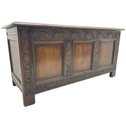 18th century oak blanket box or coffer, triple panelled hinged lid and front, the front carved with lunettes and flowerhead guilloche decoration 