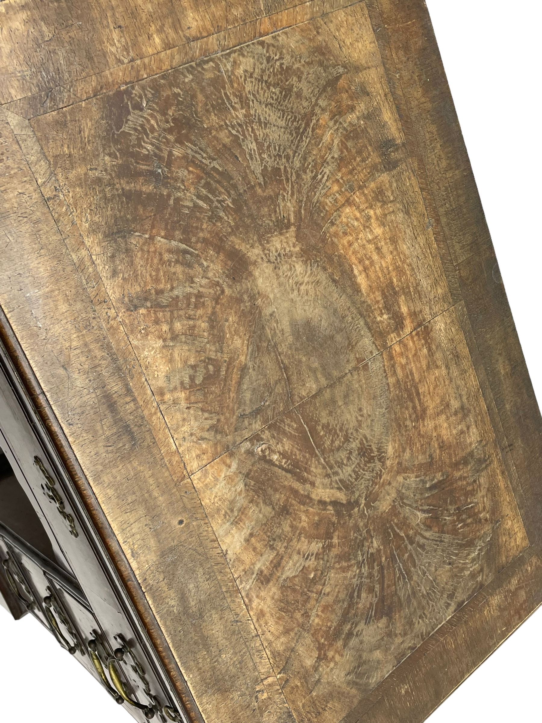 Georgian walnut kneehole desk, moulded rectangular top with book-matched veneers within crossbanding, fitted with slide over one long drawer, frieze drawer, six small drawers and recessed cupboard, raised on bracket feet
