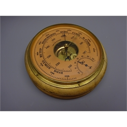  Russian aneroid barometer, circular salmon dial with subsidiary temperature dial and brass bezel, stamped on back 0580231 with paper label, D22cm   