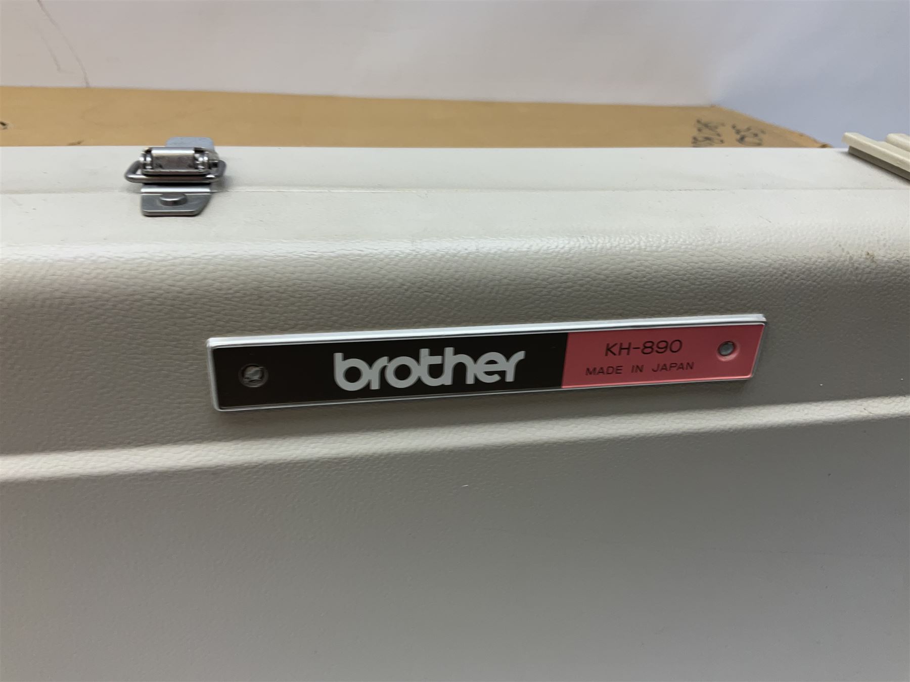  Brother cased knitting machine model KH-890 together with Brother Ribbing attachment model KH-850, knitting machine yarn cones in assorted colours, selection of knitting patterns etc