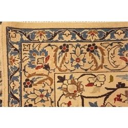 Persian Nain carpet, floral design on dark blue field, central rosette medallion, ivory ground outer border, 430cm x 305cm