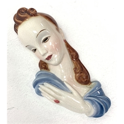 A 20th century American Goldscheider Art Deco wall mask, modelled as a brunette haired female in blue dress, with printed marks to interior, Goldscheider Everlast, H36cm. 