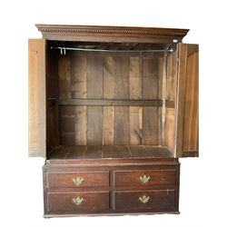 George III oak press cupboard, dentil cornice over two arch fielded panel doors, the base fitted with four drawers with pressed brass handle plates