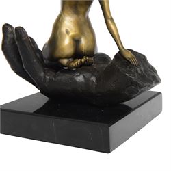 Nude In Hand bronze sculpture modeled as a female nude seated in a hand upon a marble base, signed June H24cm   