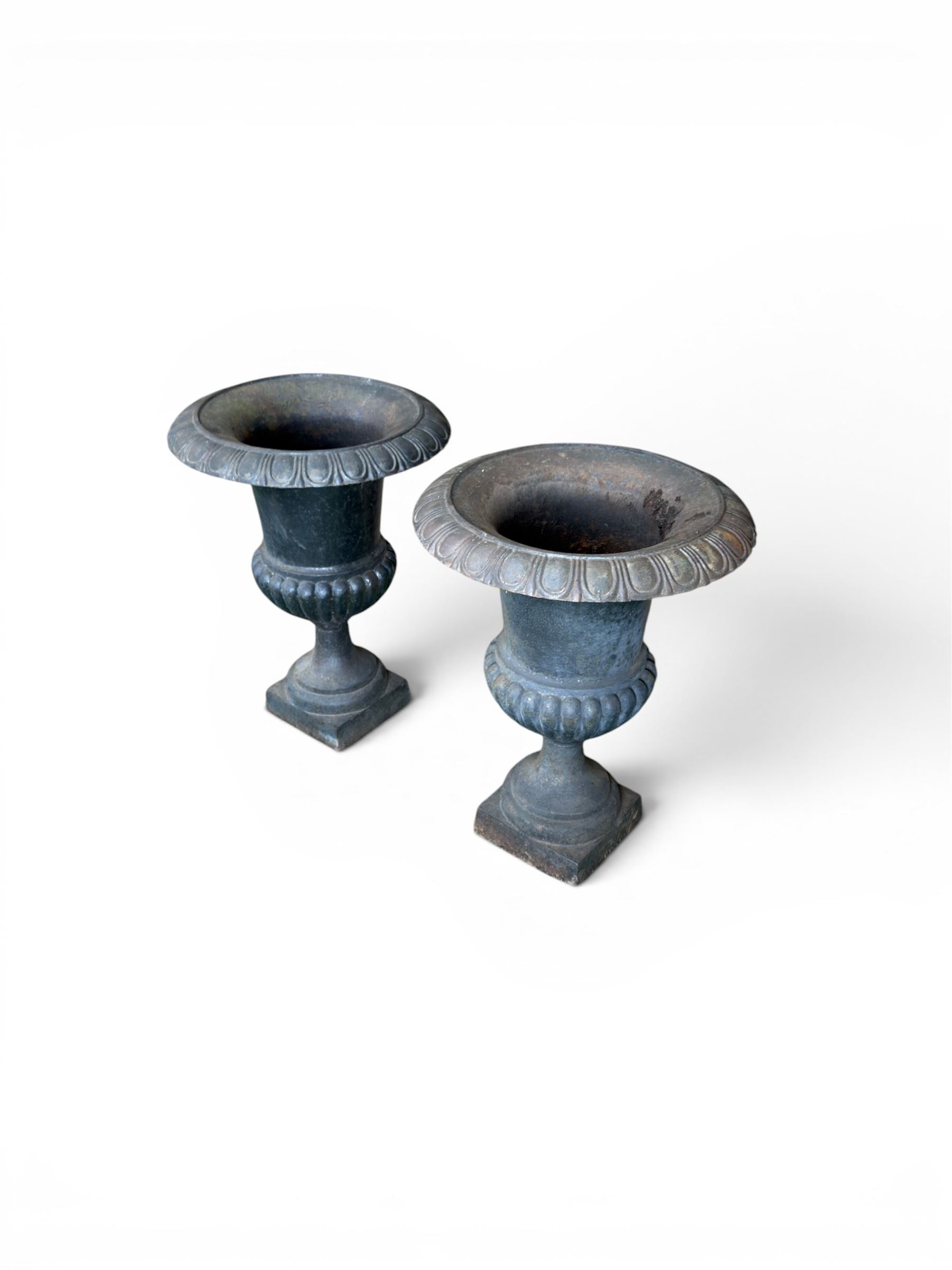 Pair of Victorian design heavy cast iron garden urns, black painted, egg and dart rim on waisted column