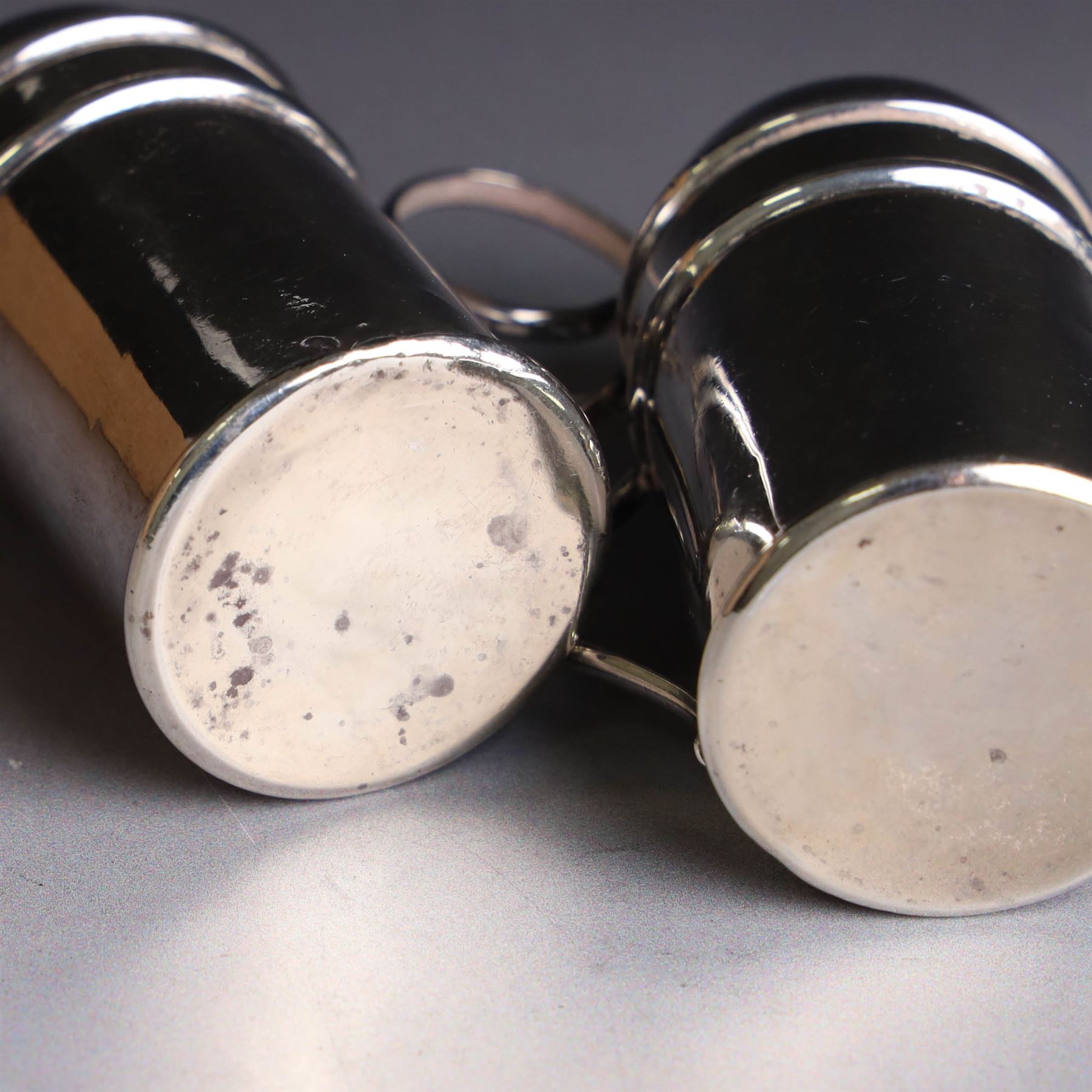Pair of Edwardian silver muffineers, of cylindrical form with C scroll handles and removable pierced covers, hallmarked G E Walton & Co Ltd, Birmingham 1906, H6cm