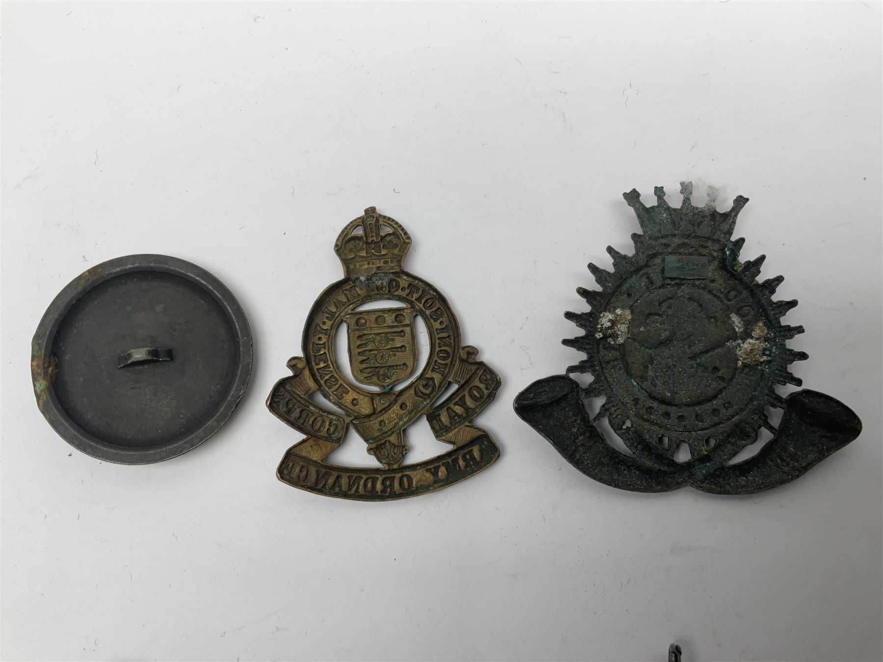 Made-up group of three WWI medals comprising 1914 Star awarded to 23598 Gnr. F. Jefferson R.G.A., British War Medal and Victory Medal with names removed; with ribbons on wearing bar; 1942 Motorist's Medal and small quantity of cap badges, Royalty badges etc