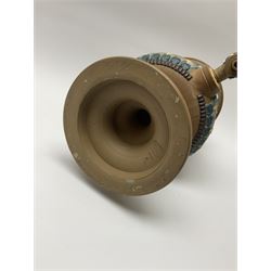 A late 19th century Doulton Lambeth stoneware water filter with original spigot, decorated with relief moulded foliate bands, with impressed marks and monogrammed for Laura Gooderham beneath, H34cm. 