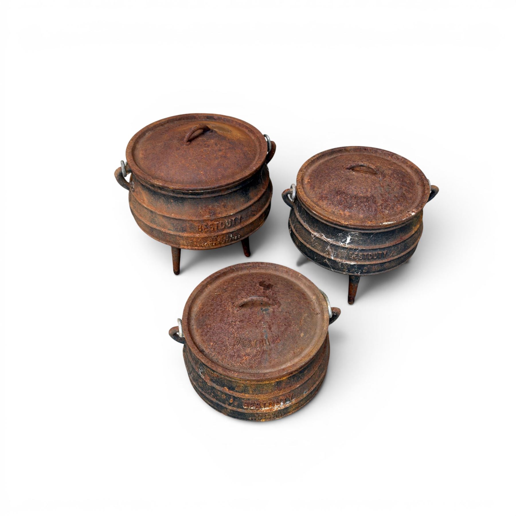 Three South African cast iron graduating cooking pots with lids and handles. Size shown for the largest