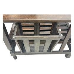 Late Victorian oak steamer chair, adjustable slatted backrest with grooved crest rail, wide armrests extending to a sliding adjustable footrest, open frame sides with vertical slats, side magazine rack and collapsible table, raised on turned front supports