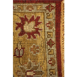 Indian woollen rug, red ground with gold floral decoration and border, 187cm x 121cm  