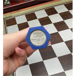 Danbury Mint 'The Fantasy of the Crystal' chess set consisting of mythical pewter chess pieces within a wooden case with chess board lid, together with 16 additional chess pieces in a wooden display case.