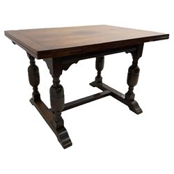 Mid-20th century medium oak dining table, rectangular draw-leaf extending top, quadruple turned pillar supports on sledge feet joined by stretcher