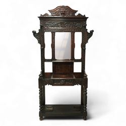 Early 20th century Victorian Jacobean revival carved oak hallstand, the shaped and foliate...