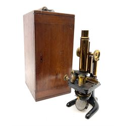 Late 19th/early 20th century brass and black enamelled monocular microscope, probably by Carl Zeiss Jena, with triple adjustable lens, movable oblong table and rack-and-pinion focussing, bears Agent's stamp for J. Woolley Sons & Co. Ltd. Victoria Bridge Manchester H31cm, in fitted mahogany carrying case with three additional lenses marked Carl Zeiss Jena