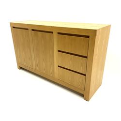 Light oak sideboard fitted with two cupboards and three drawers